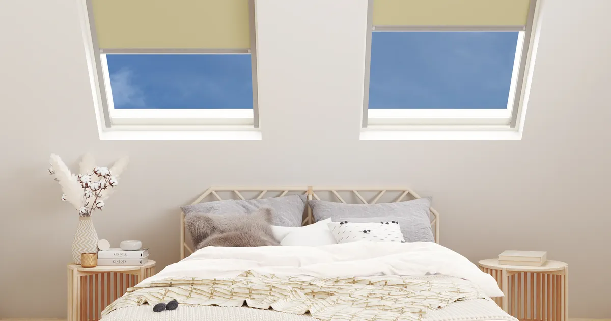 Attic bedroom with two roof windows fitted with Flax Blackout blinds part-way down